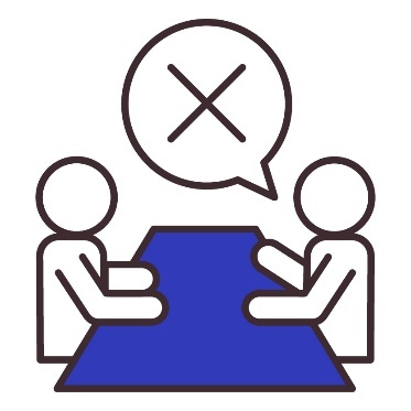 2 people sitting at a table. Above is a speech bubble showing a cross.